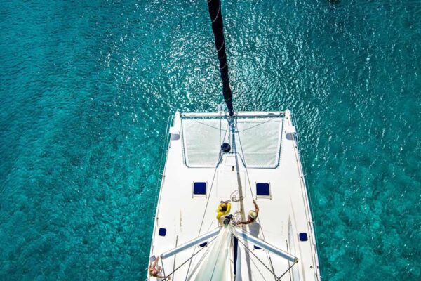 Drone view above sailboat on blue water in Barbados